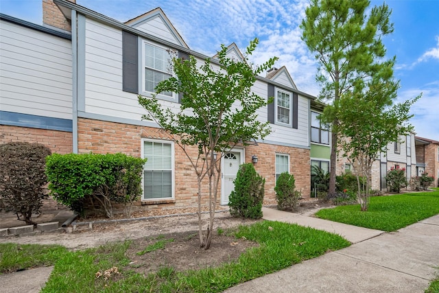 townhome / multi-family property with brick siding