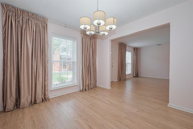 772 Thicket Ln, Houston, TX 77079 - empty room with baseboards, light wood finished floors, and a notable chandelier