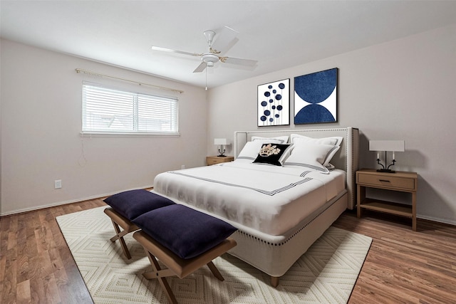 bedroom featuring baseboards, ceiling fan, and wood finished floors