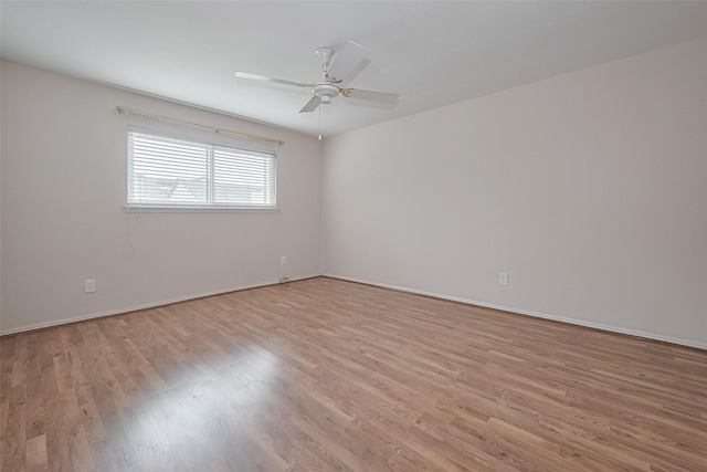 unfurnished room featuring baseboards, ceiling fan, and light wood-style flooring