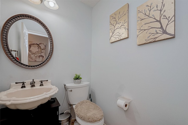 half bathroom with toilet and vanity