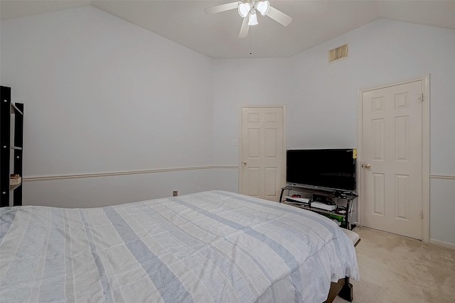 bedroom with vaulted ceiling, light colored carpet, and a ceiling fan