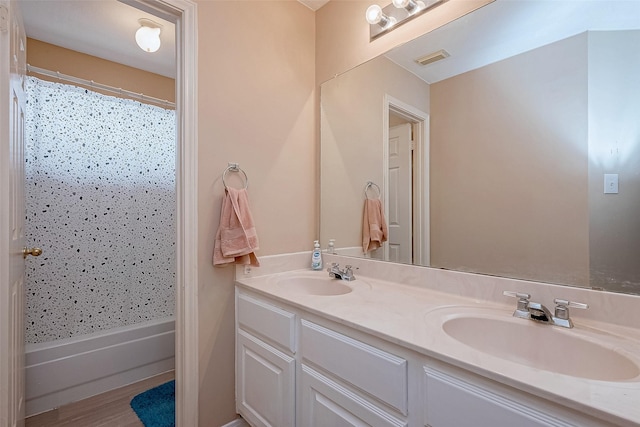 full bathroom featuring double vanity, wood finished floors, and shower / bathtub combination with curtain