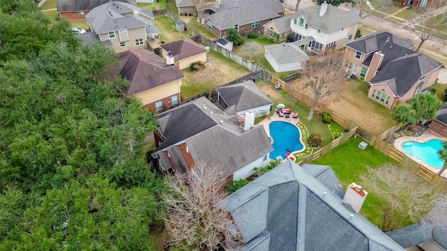 aerial perspective of suburban area featuring a pool area