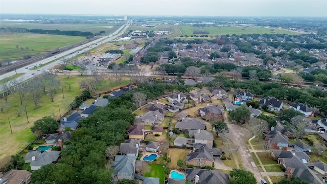 aerial view of property and surrounding area featuring nearby suburban area