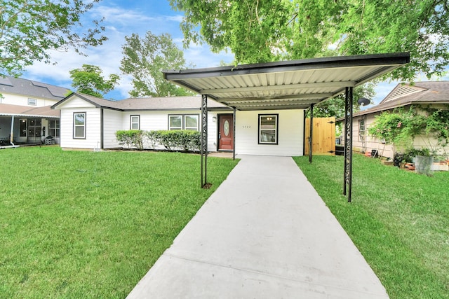 single story home featuring concrete driveway and a front lawn