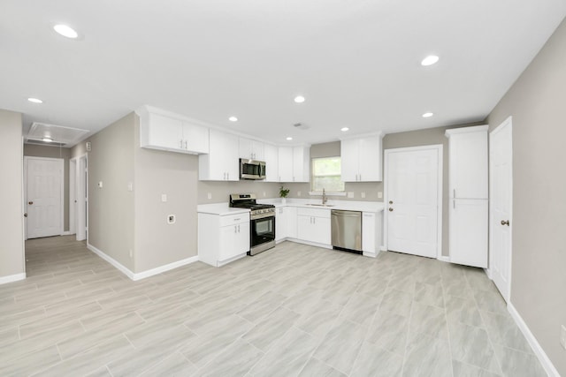 kitchen with baseboards, light countertops, white cabinetry, a sink, and stainless steel appliances