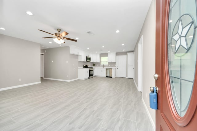 unfurnished living room with baseboards, recessed lighting, ceiling fan, and visible vents
