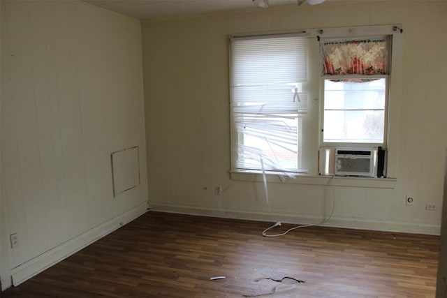 spare room with baseboards, a healthy amount of sunlight, and wood finished floors