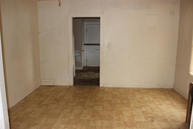 unfurnished room featuring baseboards