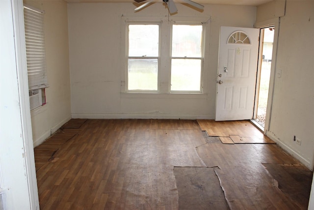 entryway with a ceiling fan, baseboards, wood finished floors, and cooling unit