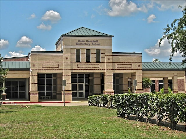 1519 Brookstone Ln, Sugar Land, TX 77479 - rear view of property featuring a standing seam roof, metal roof, and a lawn