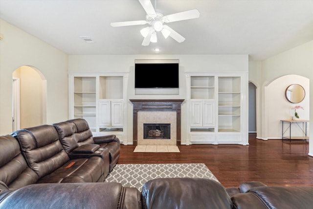 1519 Brookstone Ln, Sugar Land, TX 77479 - living room featuring arched walkways, ceiling fan, wood finished floors, and built in shelves