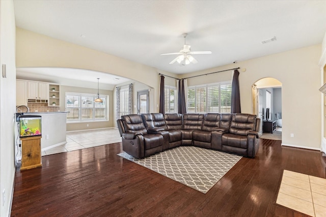 1519 Brookstone Ln, Sugar Land, TX 77479 - living area with arched walkways, a ceiling fan, hardwood / wood-style flooring, and healthy amount of natural light