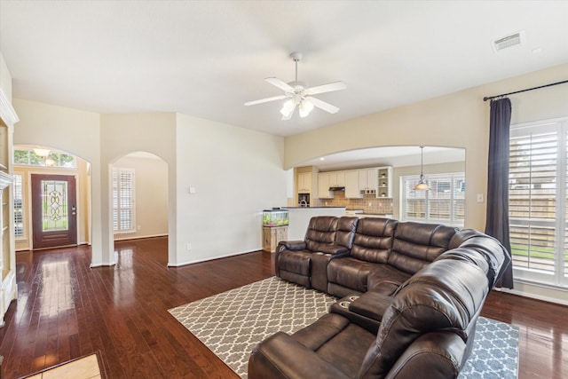 1519 Brookstone Ln, Sugar Land, TX 77479 - living area with arched walkways, a ceiling fan, baseboards, and plenty of natural light