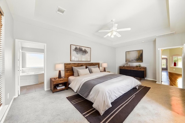 1519 Brookstone Ln, Sugar Land, TX 77479 - carpeted bedroom featuring a tray ceiling, baseboards, ensuite bath, and ceiling fan