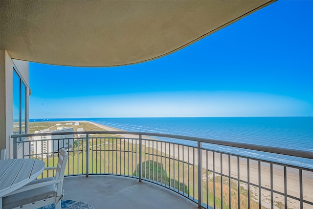balcony featuring a beach view and a water view