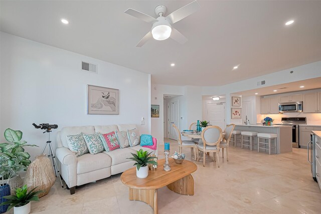 living room with visible vents, a ceiling fan, and recessed lighting