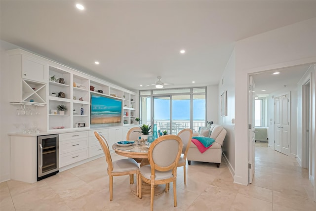 dining space featuring beverage cooler, recessed lighting, ceiling fan, and a bar