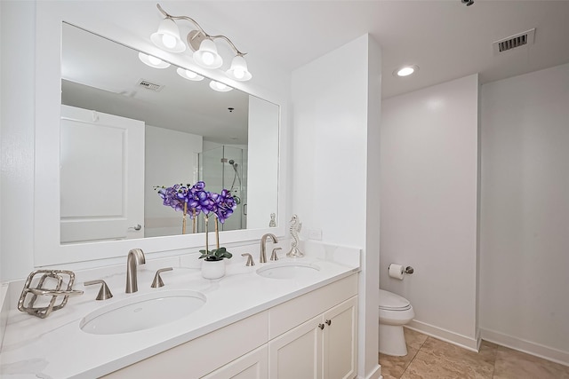 full bath featuring visible vents, a sink, toilet, and a shower stall