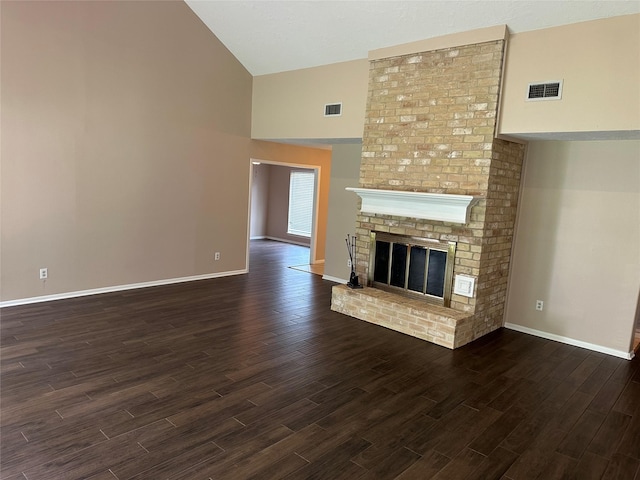 unfurnished living room featuring visible vents, dark wood-style flooring, baseboards, and high vaulted ceiling