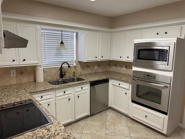 kitchen with decorative backsplash, exhaust hood, a sink, white cabinets, and stainless steel appliances