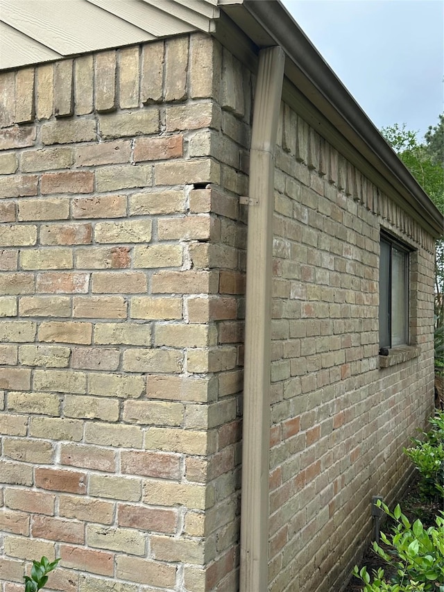 view of side of property featuring brick siding