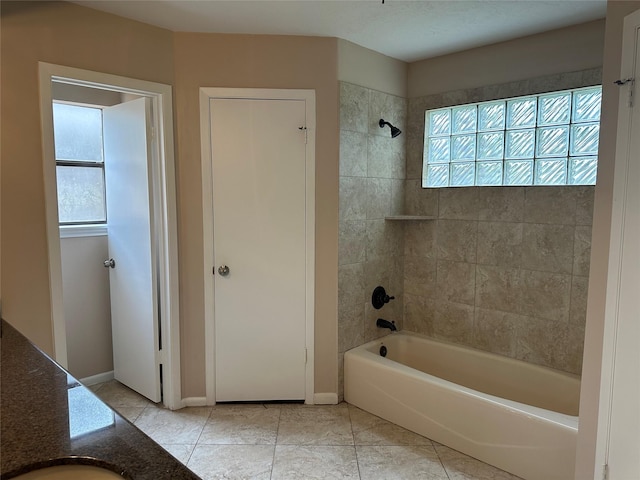 bathroom featuring tile patterned flooring, shower / bathing tub combination, and baseboards