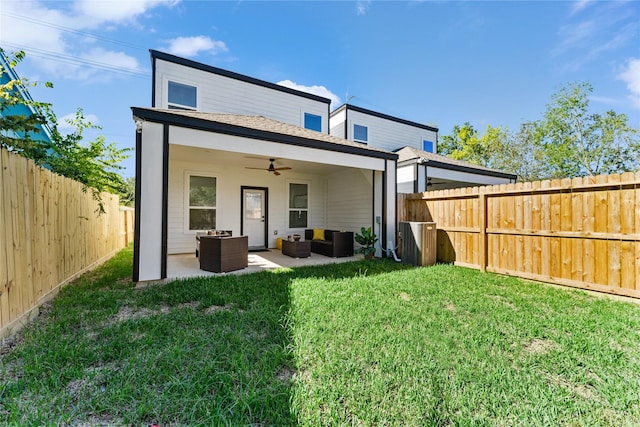 back of property featuring ceiling fan, a patio, a fenced backyard, an outdoor hangout area, and a yard