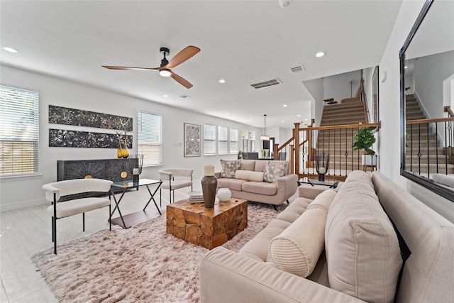 living area with ceiling fan, visible vents, stairway, baseboards, and recessed lighting