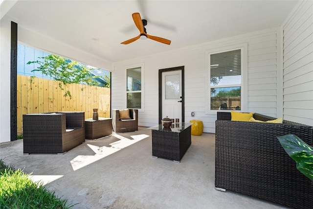 view of patio featuring fence, ceiling fan, and outdoor lounge area