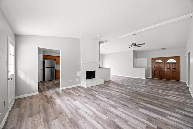 8803 Enchanted Forest Dr, Houston, TX 77088 - unfurnished living room featuring baseboards, a ceiling fan, wood finished floors, and a fireplace