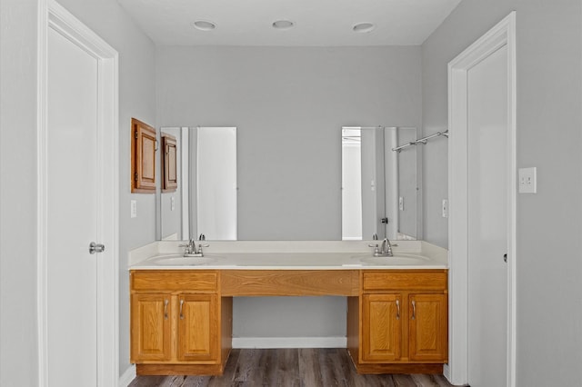 8803 Enchanted Forest Dr, Houston, TX 77088 - full bath with double vanity, a sink, and wood finished floors
