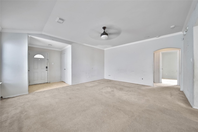 unfurnished living room featuring arched walkways, ceiling fan, visible vents, and carpet