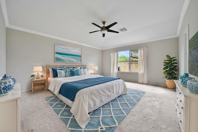 bedroom with light colored carpet, a ceiling fan, visible vents, and ornamental molding