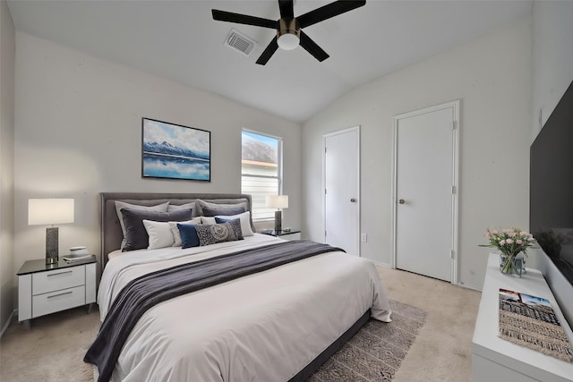 bedroom with ceiling fan, light carpet, vaulted ceiling, and visible vents