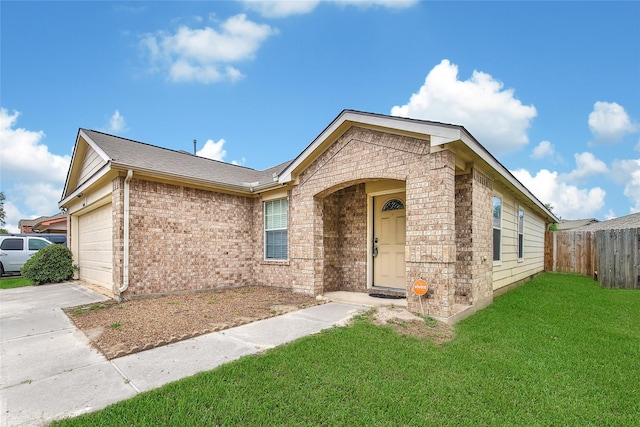 ranch-style home featuring fence, brick siding, a garage, a front yard, and driveway