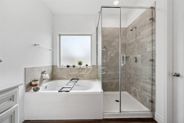 full bath with a shower stall, a garden tub, and vanity