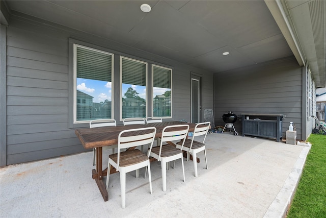 view of patio featuring outdoor dining area and a grill