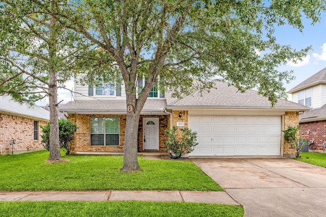 1811 Salt Valley Dr, Katy, TX 77493 - view of front of home featuring a garage, a front lawn, brick siding, a shingled roof, and driveway