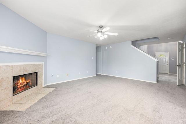 1811 Salt Valley Dr, Katy, TX 77493 - unfurnished living room featuring ceiling fan, a fireplace, carpet floors, baseboards, and stairway