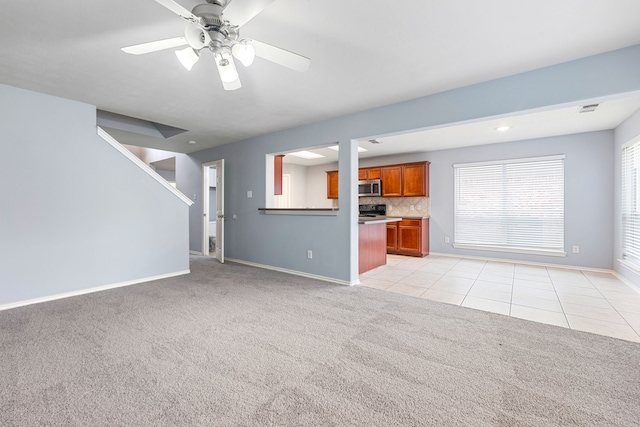 1811 Salt Valley Dr, Katy, TX 77493 - unfurnished living room featuring light tile patterned flooring, baseboards, light carpet, and ceiling fan