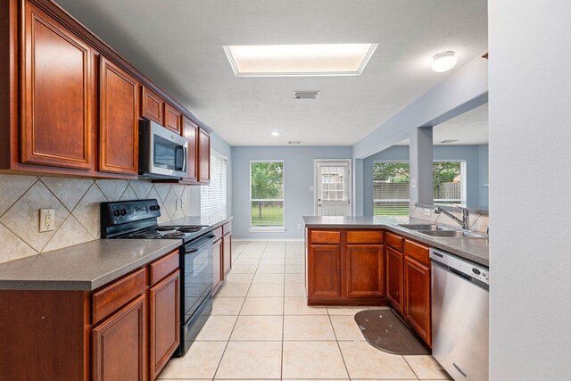 1811 Salt Valley Dr, Katy, TX 77493 - kitchen with a sink, dark countertops, stainless steel appliances, and visible vents