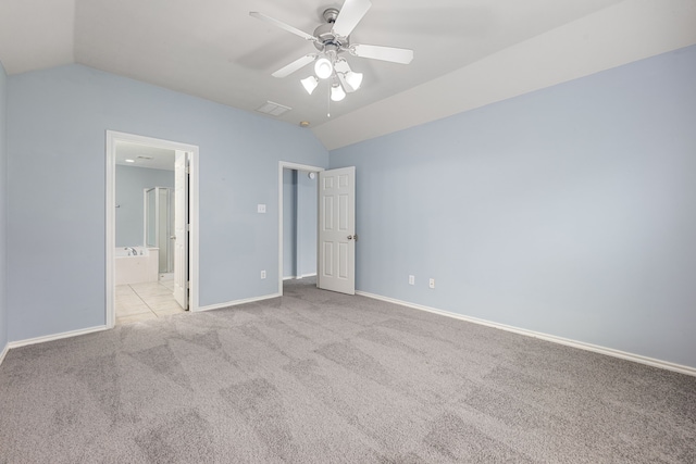 1811 Salt Valley Dr, Katy, TX 77493 - unfurnished bedroom with visible vents, carpet floors, baseboards, connected bathroom, and lofted ceiling