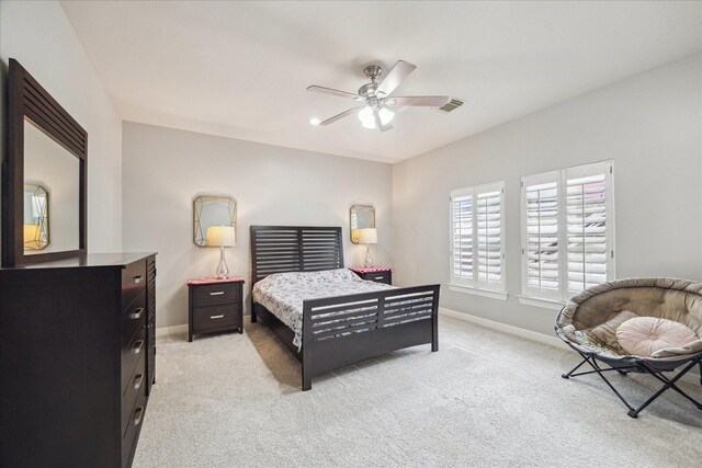 bedroom with light colored carpet, baseboards, ceiling fan, and visible vents