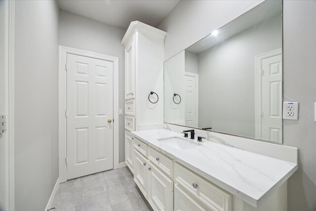 bathroom with baseboards and vanity