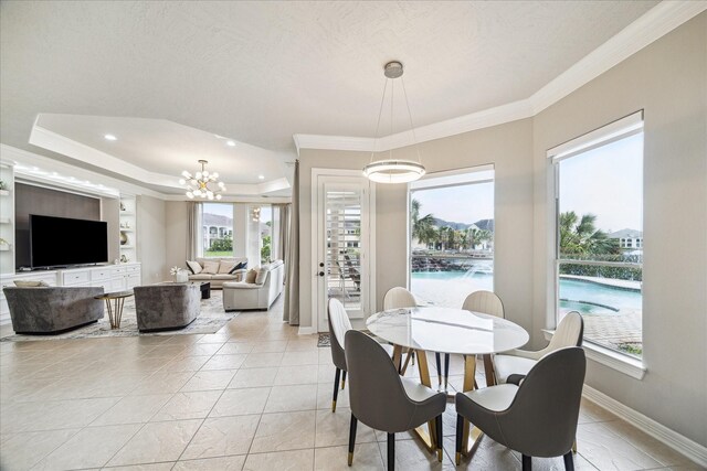 dining space with recessed lighting, baseboards, ornamental molding, and a tray ceiling