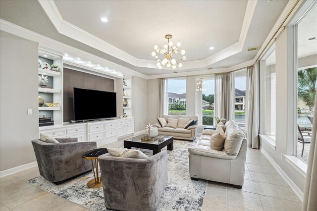 living room featuring a healthy amount of sunlight, a tray ceiling, and light tile patterned flooring