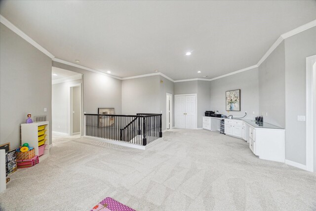 recreation room featuring recessed lighting, ornamental molding, visible vents, and light colored carpet