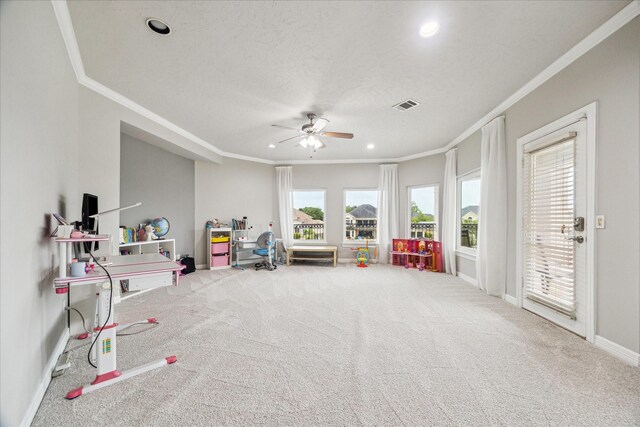rec room featuring crown molding, ceiling fan, and visible vents